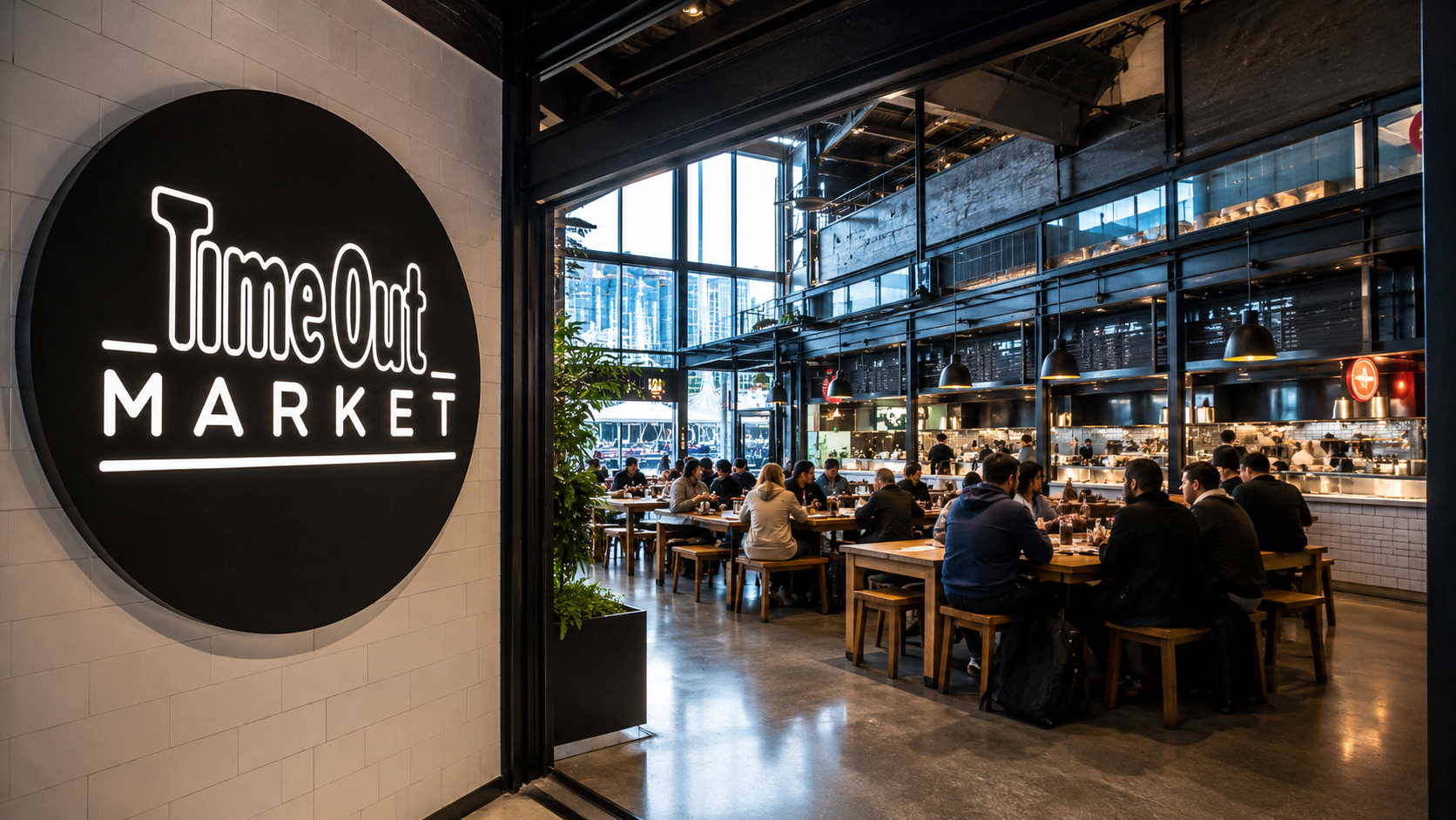 The image shows the interior of Time Out Market, featuring a spacious dining area with various food stalls. Guests are seen seated at communal tables enjoying their meals in a modern and bright environment.