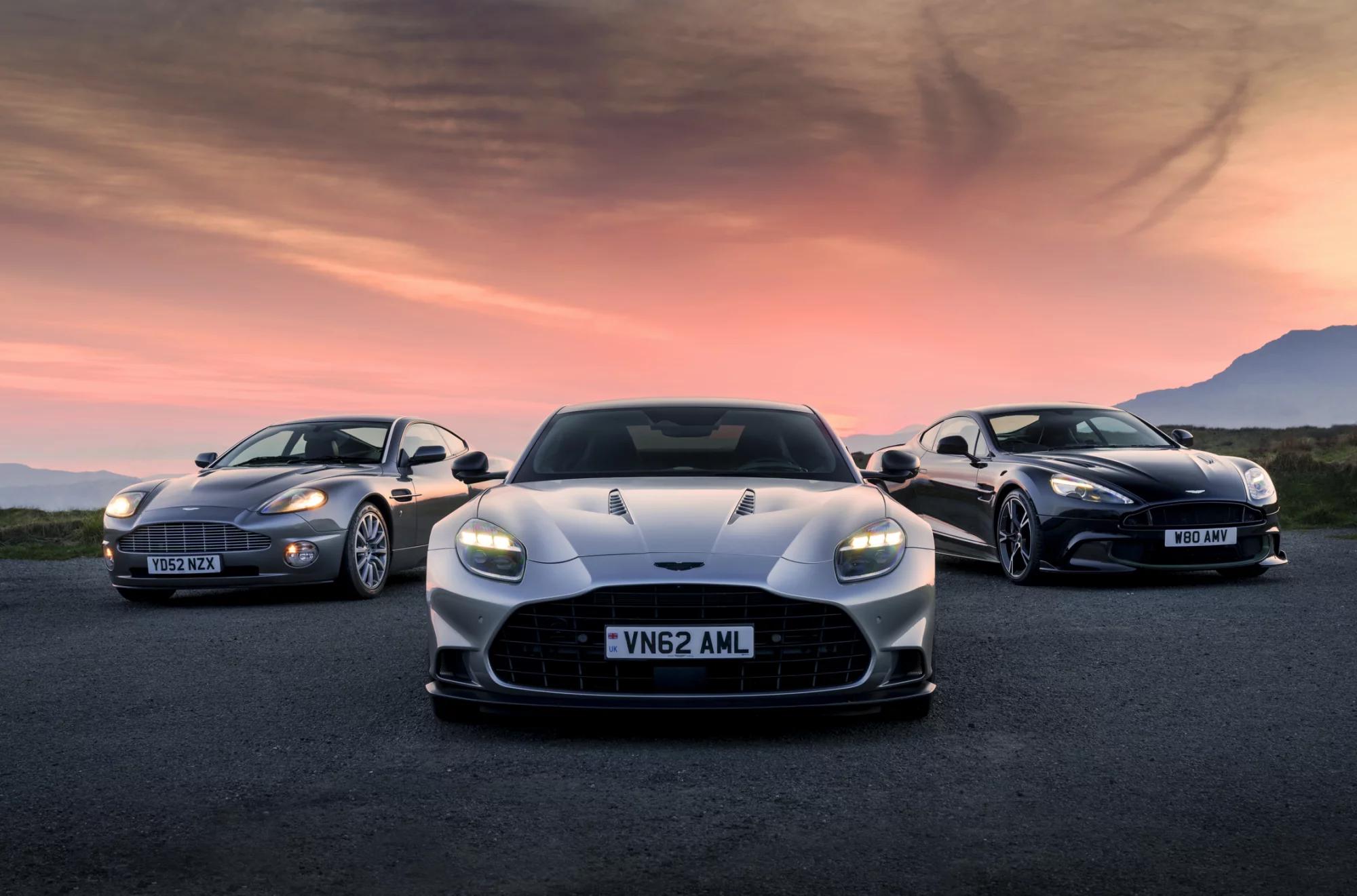 The image showcases three luxury sports cars positioned prominently against a scenic sunset backdrop. The vehicles, notable for their sleek designs and aerodynamics, are displayed on an open road with rolling hills in the background.