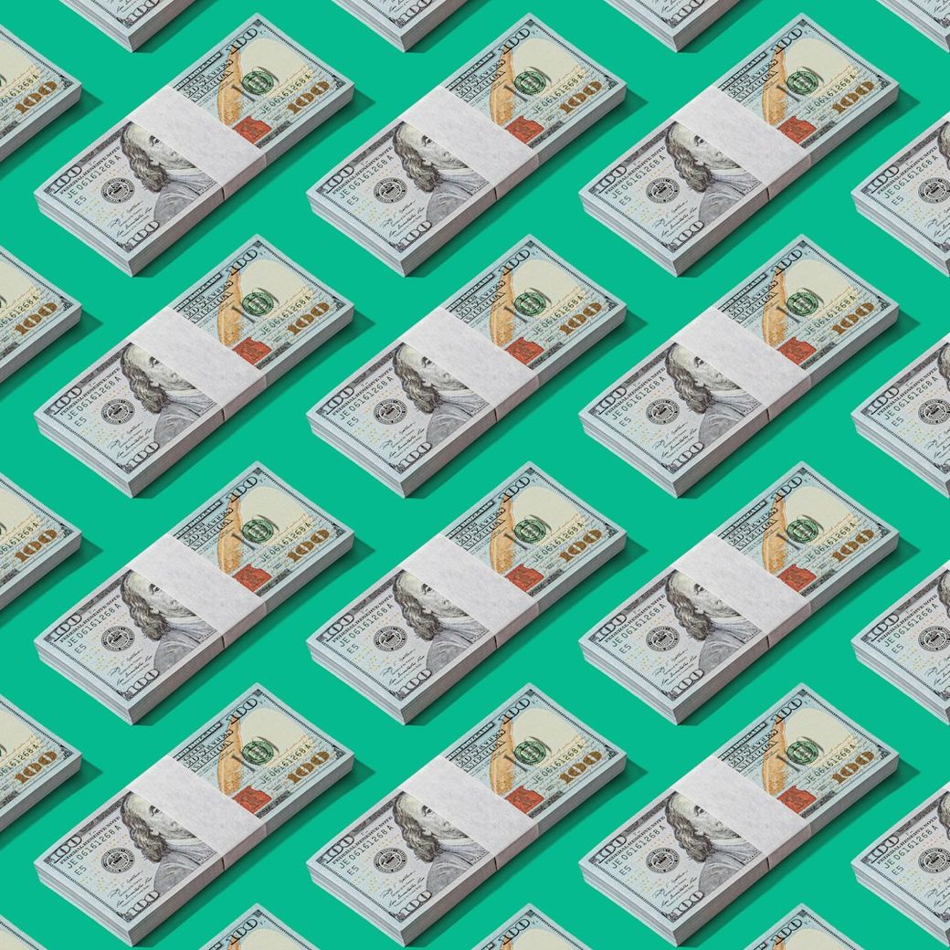 The image features a repeated pattern of stacked bundles of hundred dollar bills against a bright teal background. The arrangement emphasizes the design of U.S. currency, highlighting its intricate details. — Credit: Photo by Shamblen Studios on Unsplash