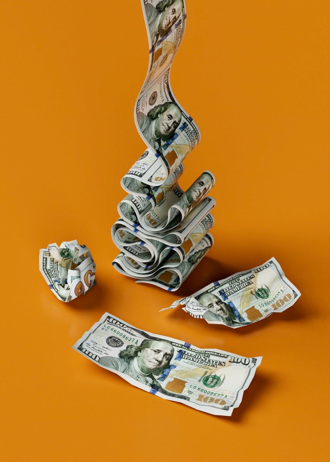 The image features a creative arrangement of U.S. dollar bills, with some bills stacked and others rolled or crumpled, set against an orange background. The artistic presentation suggests themes of finance and wealth.