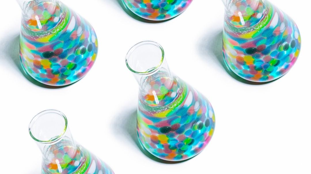 Colorful Erlenmeyer flasks on white background