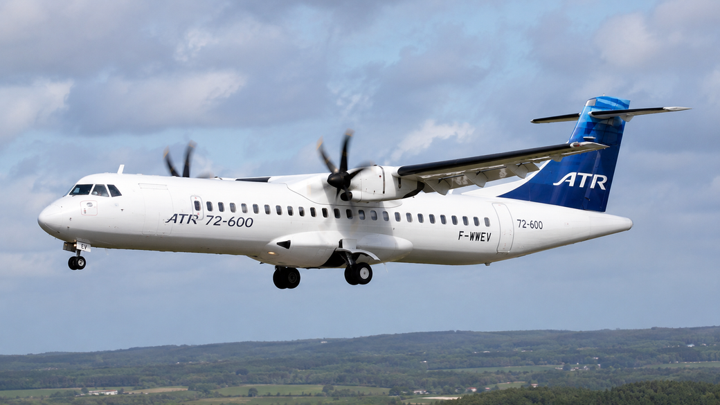 The image shows an ATR 72-600 aircraft in mid-flight, showcasing its distinctive turboprop engines and landing gear. The plane is painted in a white and blue color scheme, prominently displaying the ATR logo on the tail.