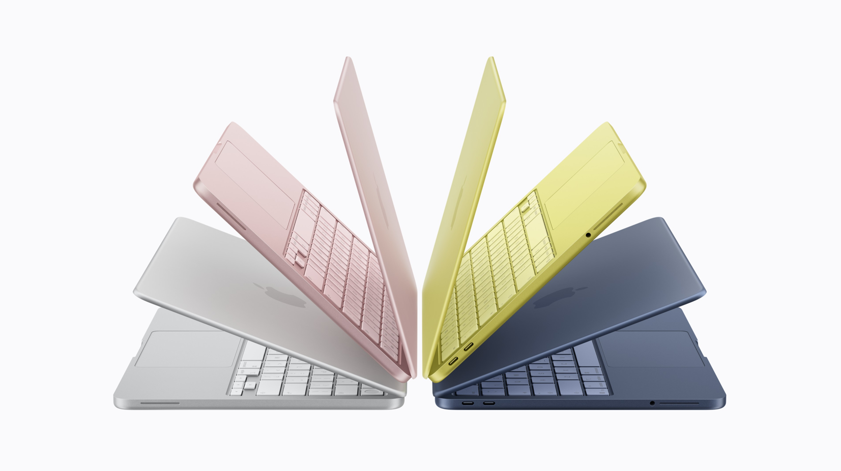 The image features four laptops arranged in a star pattern, showcasing a variety of vibrant colors. The laptops appear to be thin and modern, emphasizing their sleek design.