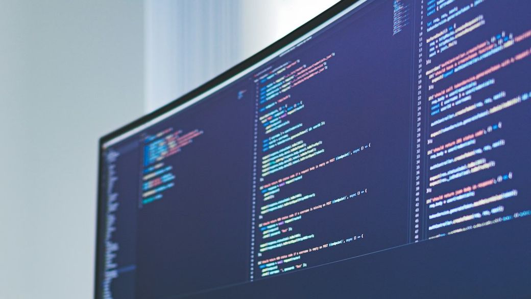 a computer monitor sitting on top of a wooden desk — Credit: Photo by Karl Pawlowicz on Unsplash