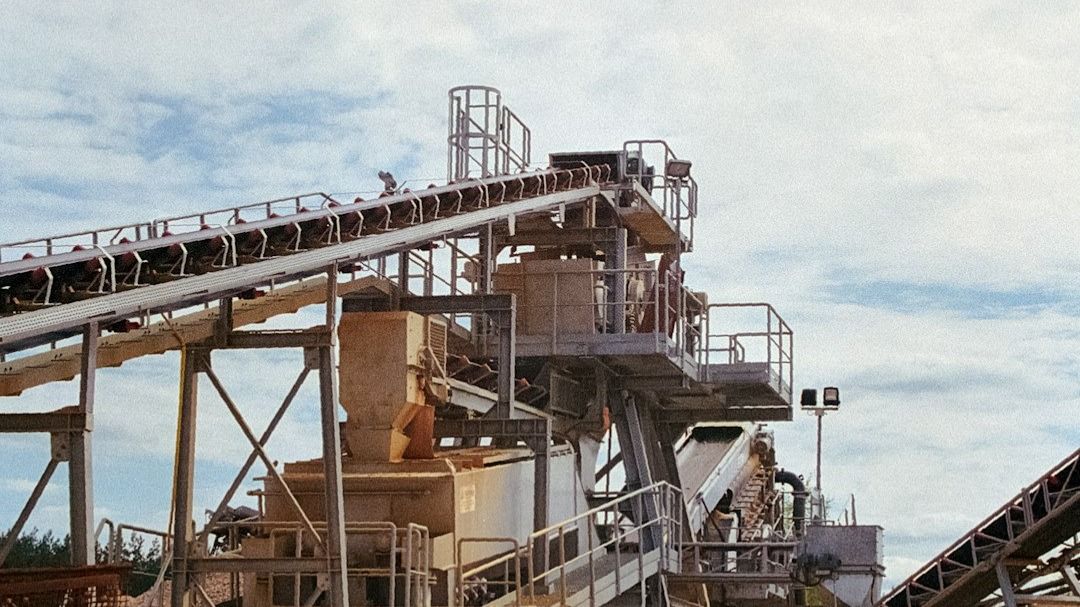 a large cement plant sitting on top of a dirt hill