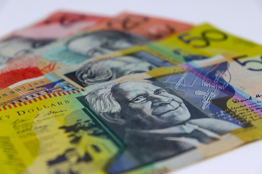 The image features a close-up view of Australian banknotes featuring various prominent figures. The notes are displayed in a fanned arrangement, showcasing their distinctive colors and designs. — Credit: Photo by Debora Cardenas on Unsplash