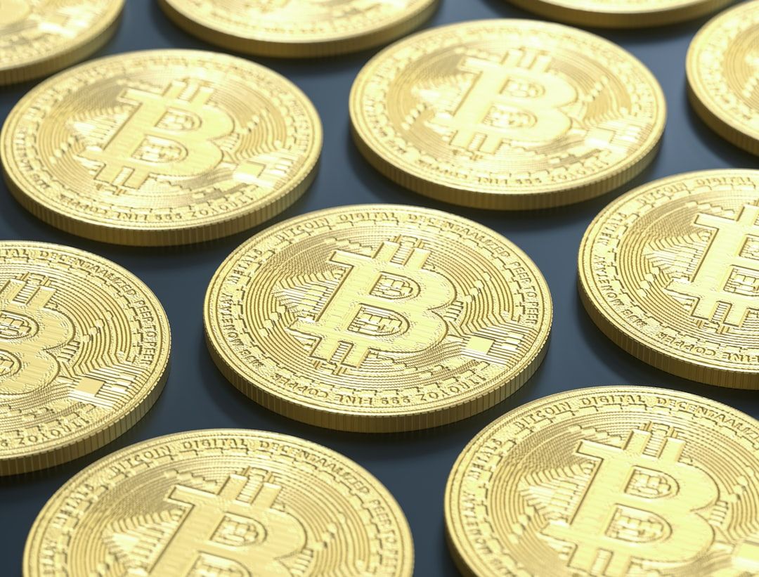 The image features a close-up view of multiple Bitcoin coins arranged in a repetitive pattern. The coins display the Bitcoin logo and intricate details, emphasizing the digital currency's design.