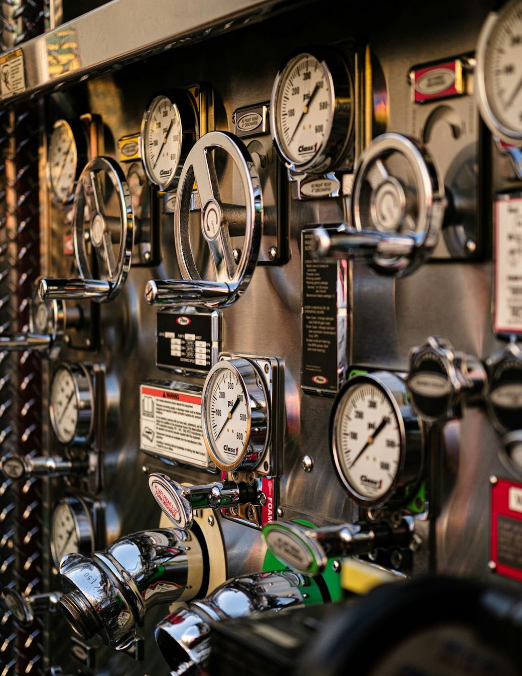 The image showcases a close-up view of various pressure gauges and valves mounted on a metallic panel, often found in mechanical or industrial settings. The instruments are designed for monitoring pressure levels, indicating their functionality and precision. — Credit: Photo by Gabe De La Rosa on Unsplash