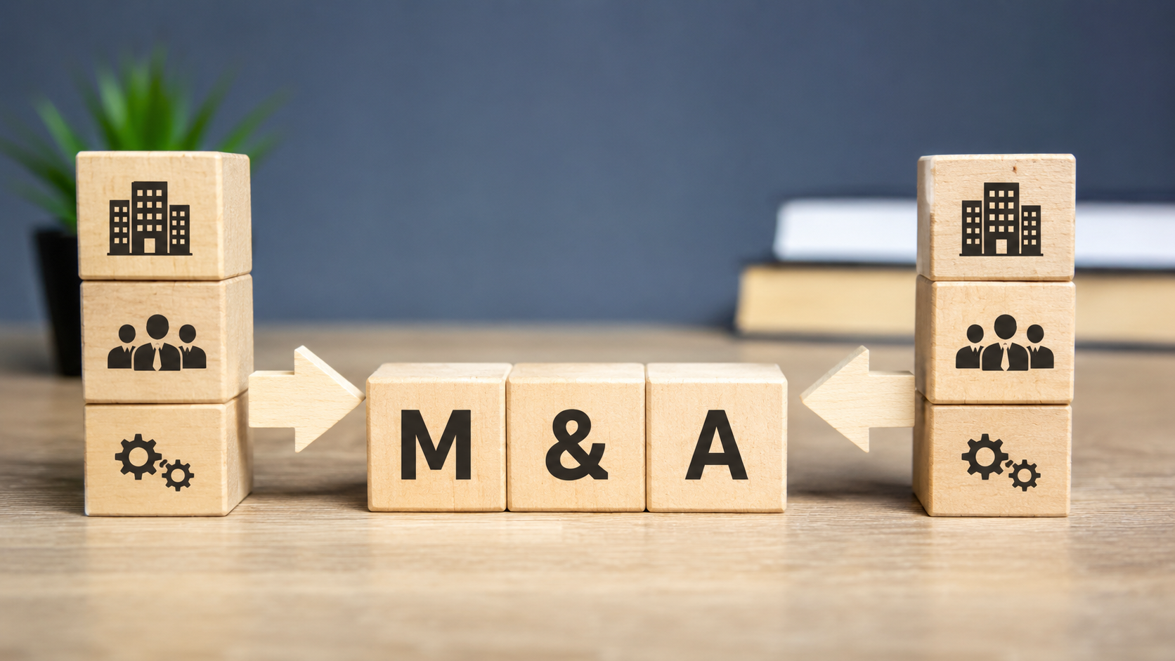 The image features wooden blocks arranged on a desk, prominently displaying the letters 'M & A' at the center, symbolizing mergers and acquisitions. Flanking the central blocks are icons representing companies and teamwork, underscoring the collaborative nature of business takeovers.