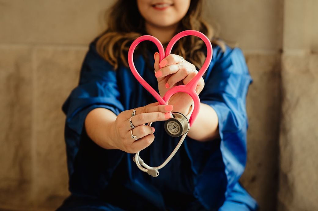 girl in blue jacket holding red and silver ring — Credit: Photo by Patty Brito on Unsplash