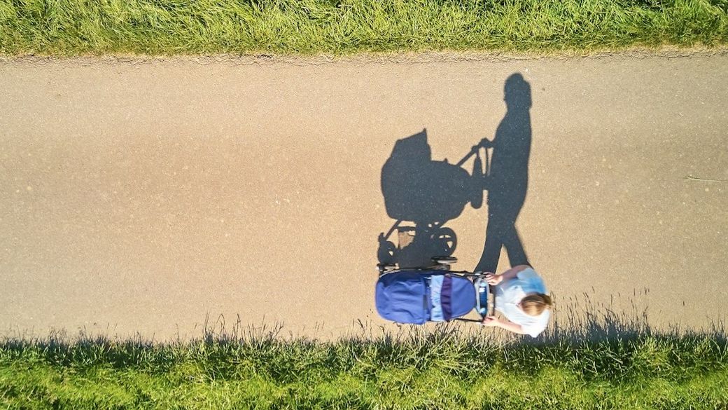 My wife while we were on one of our first walks with our firstb-born. — Credit: Photo by Johny Goerend on Unsplash