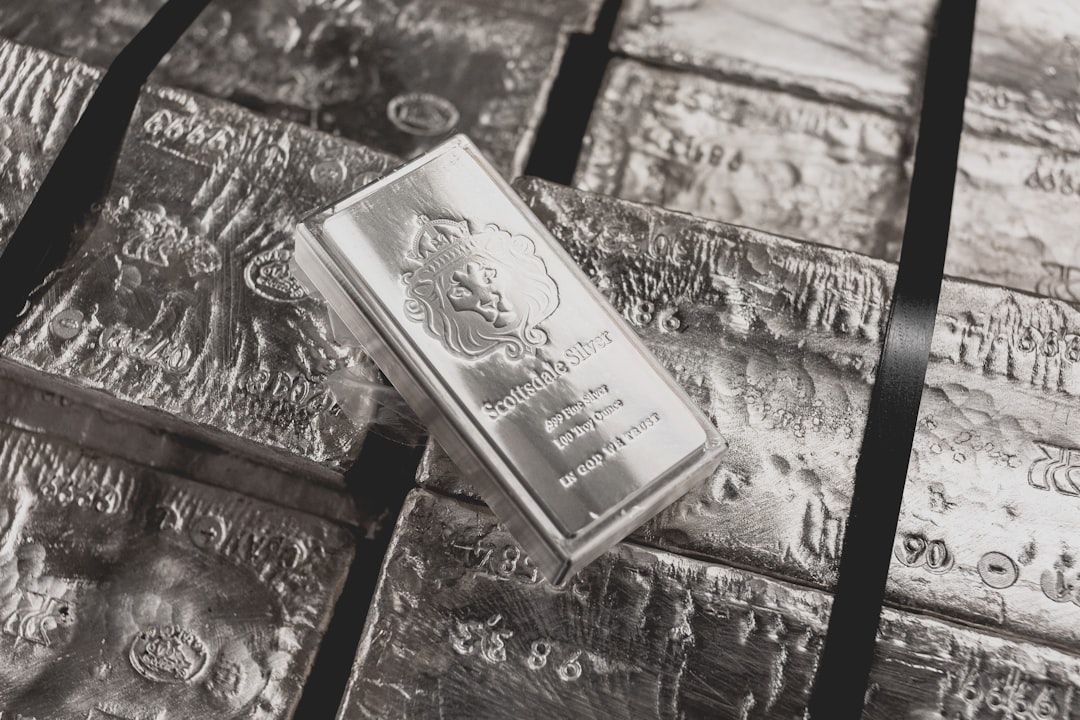 The image features stacked silver bars, prominently displaying a silver ingot labeled 'Scotiabank Silver.' The bars show intricate designs and textures typical of bullion, indicating a focus on precious metals.
