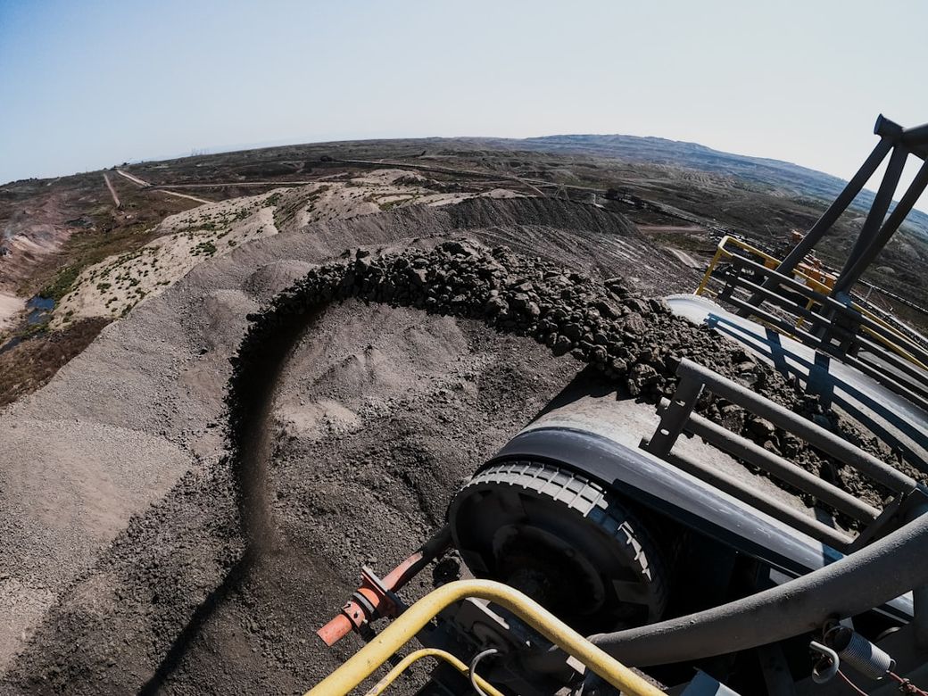 black and yellow heavy equipment on brown sand — Credit: Photo by Albert Hyseni on Unsplash