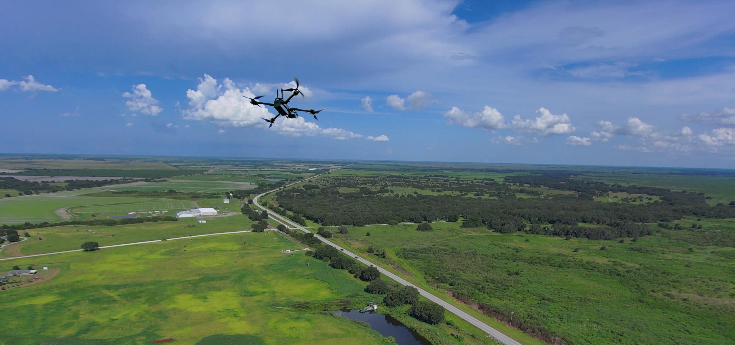 Drone in flight over rural stretch of highway landscape view