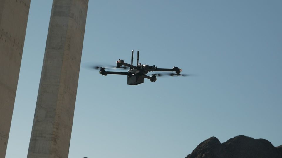 drone flying under bridge