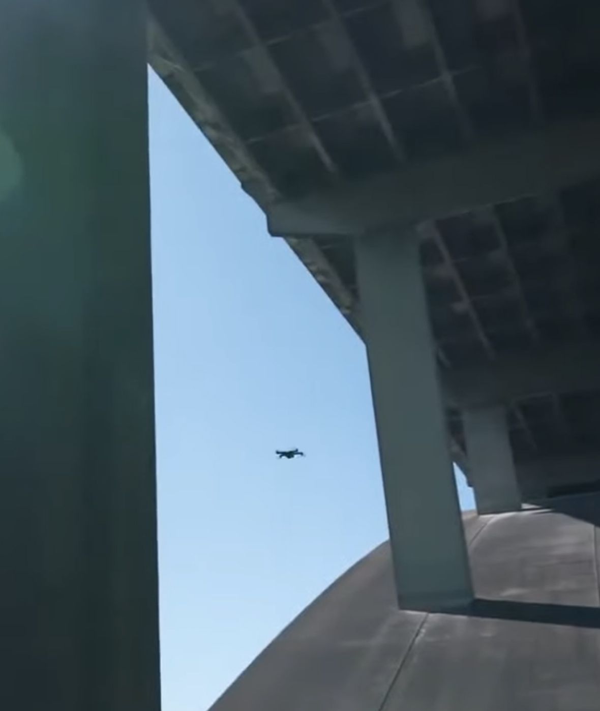 Skydio drone flying under a bridge close up
