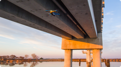 skydio drone flying under bridge
