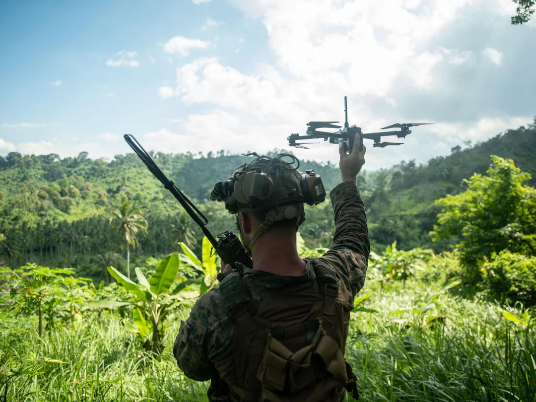 A U.S. Marine Corps small unmanned aerial system operator assigned to Weapons Company, Battalion Landing Team 1/5, 15th Marine Expeditionary Unit, launches an X2D Skydio drone. (U.S. Marine Corps photo by Sgt. Patrick Katz)