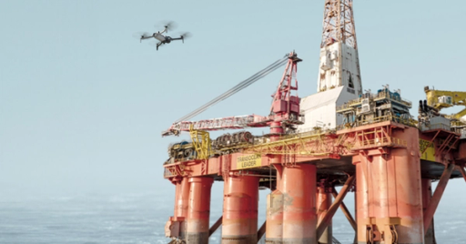 Skydio X10D drone approaching an oil rig in the ocean to performa an inspection