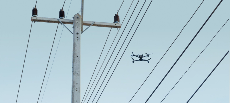 skydio X10 drone in between power lines 