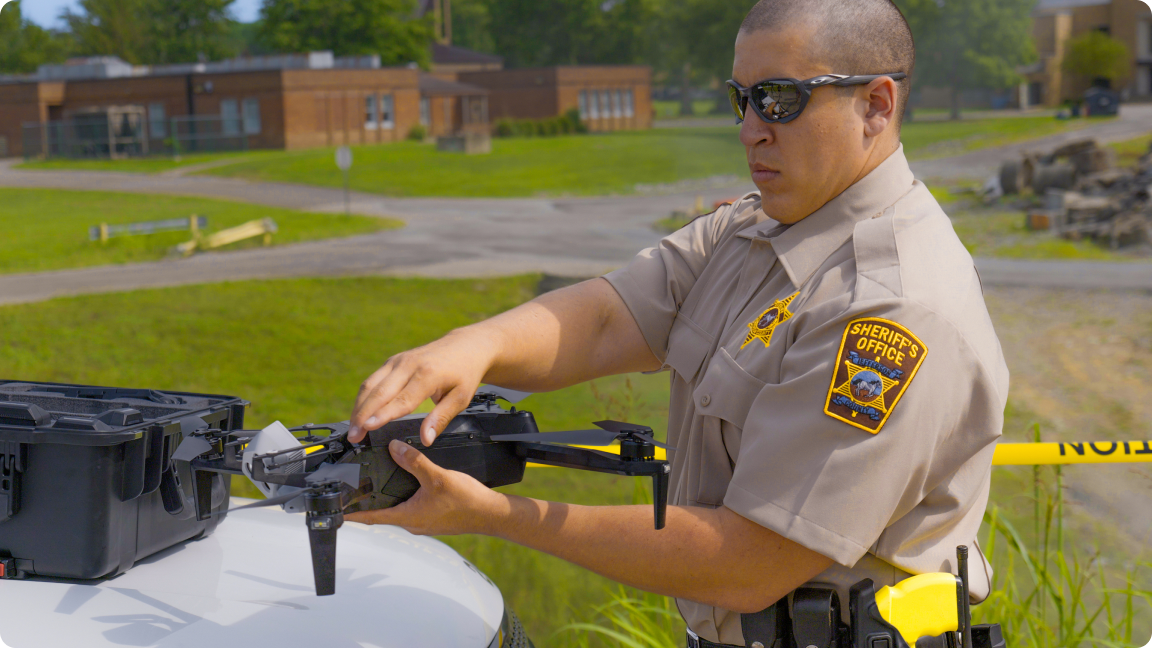 Police officee launching Skydio X2 drone from trunk of squad car