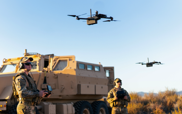 a convoy launching 2 Skydio X2D Drones from HMMWV vehicle in the desert 