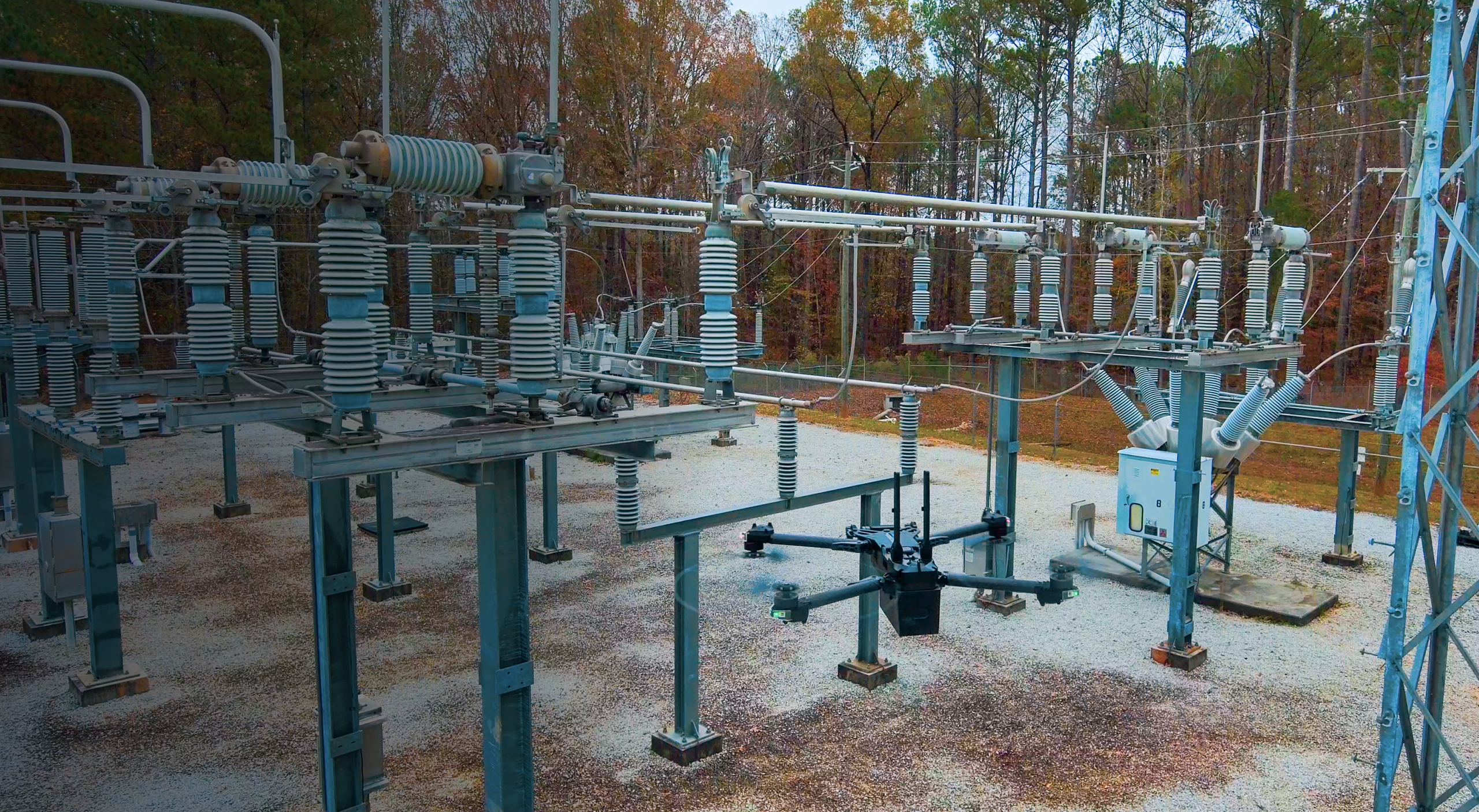 Wide view of a Skydio drone flying in a electrical power substation location