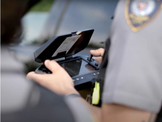 officer using skydio controller to fly drone