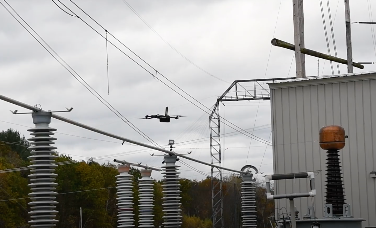 drone flying by power lines