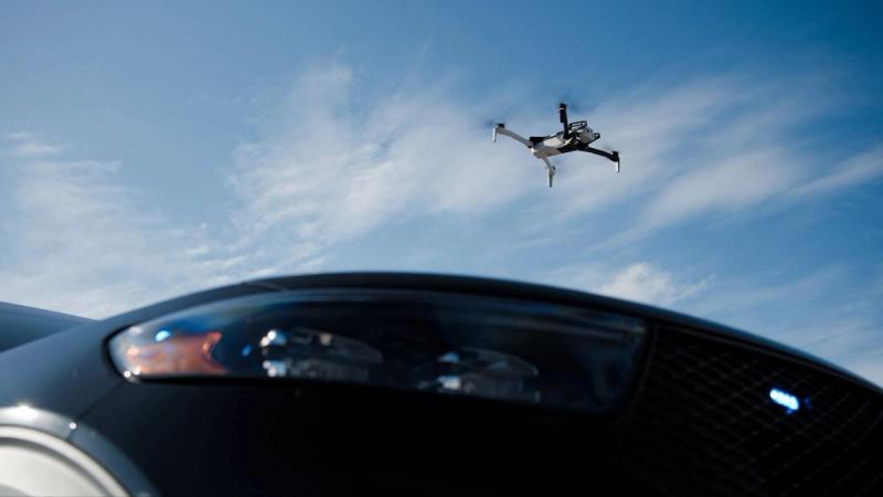 Skydio X10 hovers over patrol car