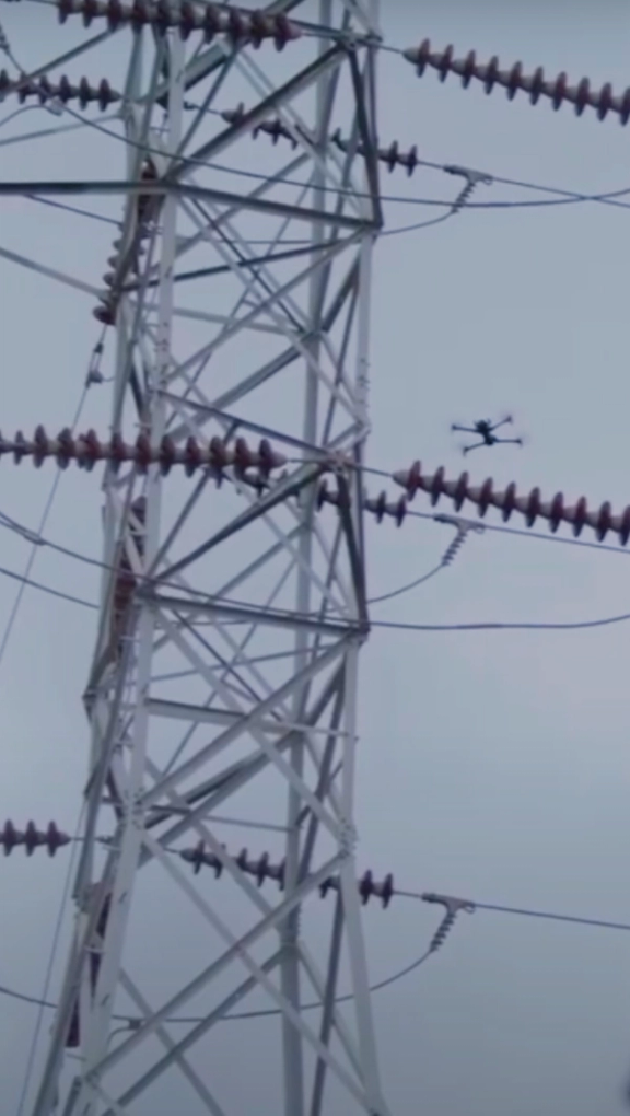 AEP worker using Skydio X10 to navigate and inspect large substation portrait orientation