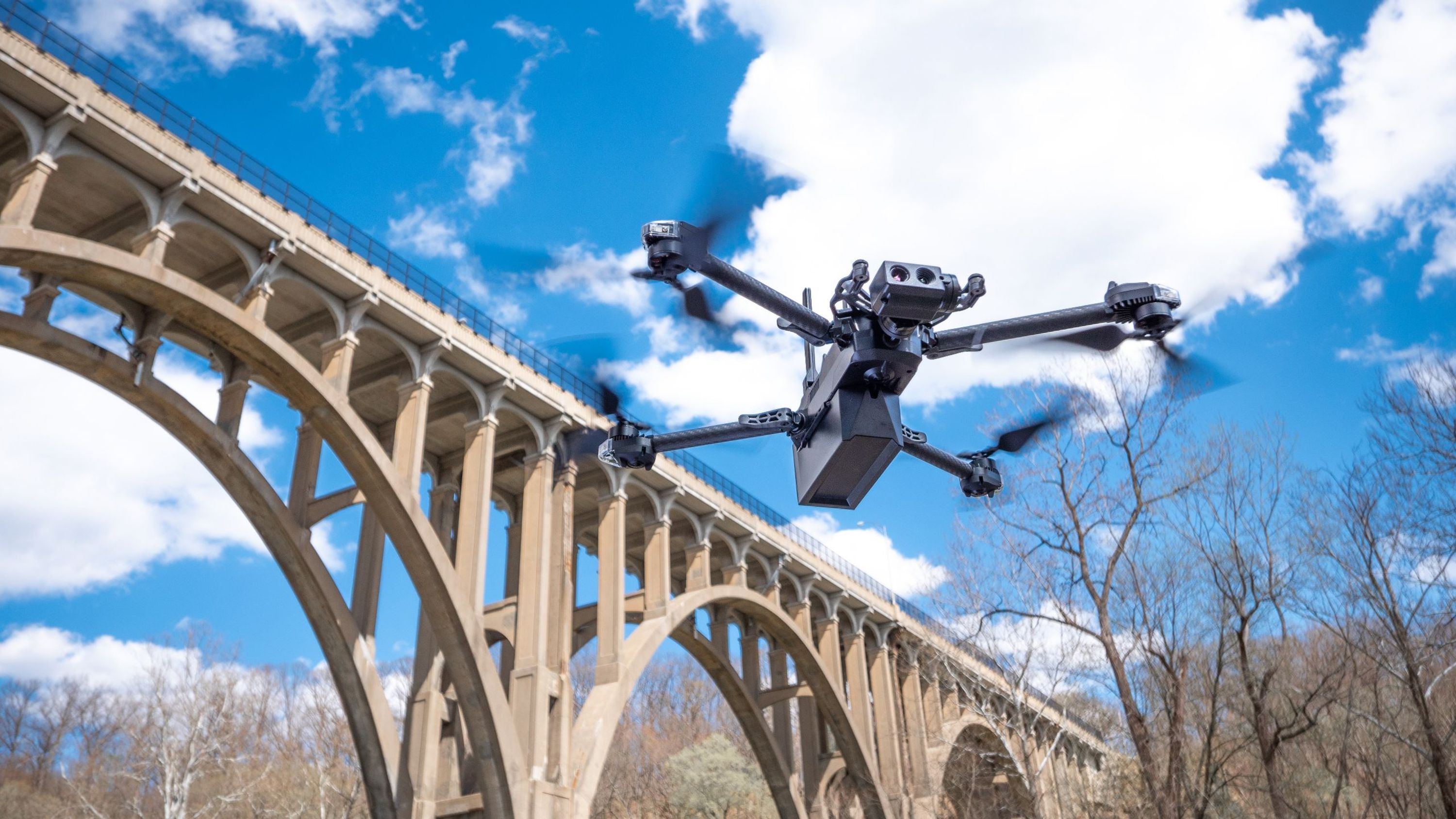 Skydio X10 inspection drone flying near bridge
