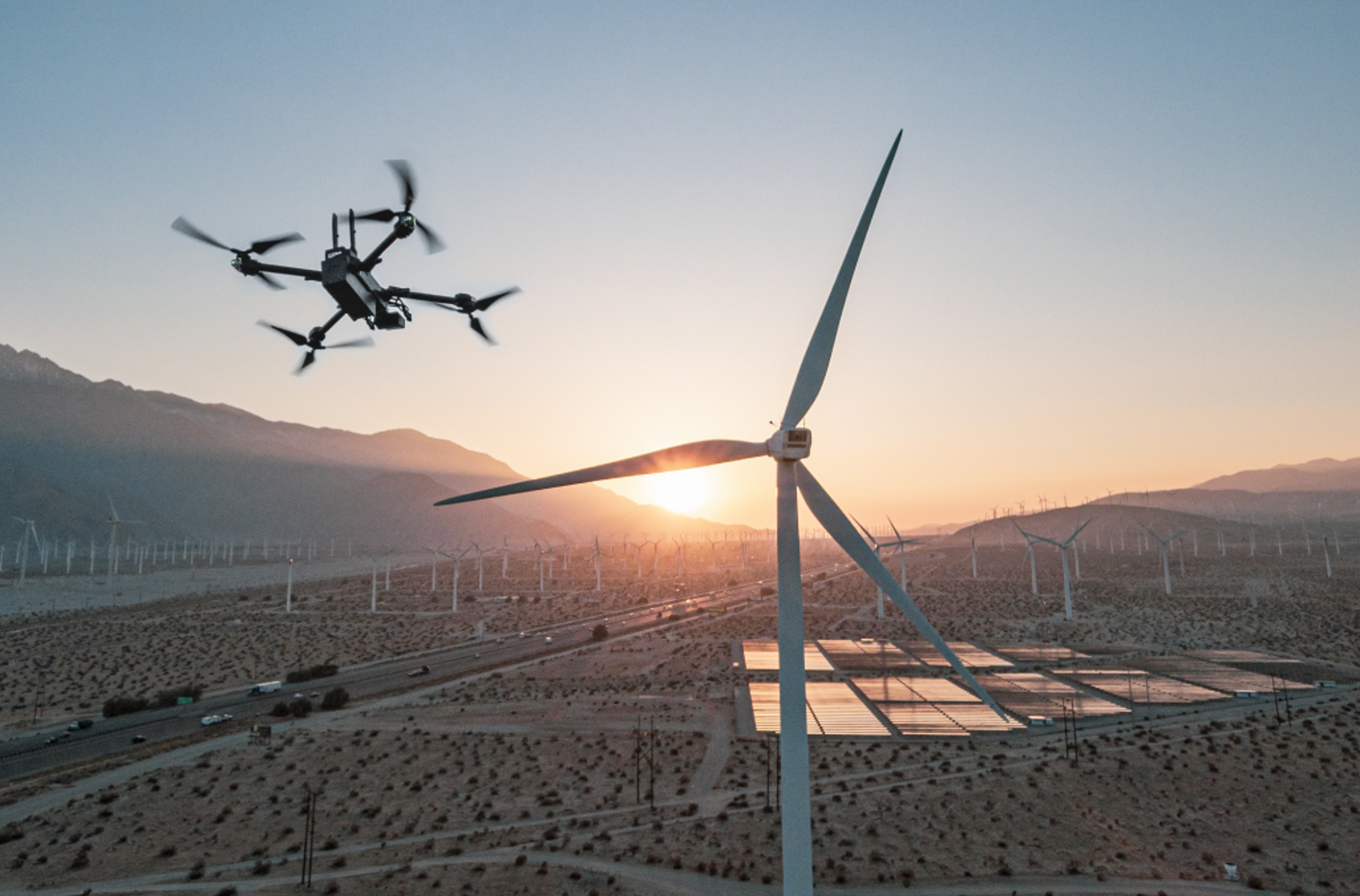 Skydio inspection drone flying over a wind farm