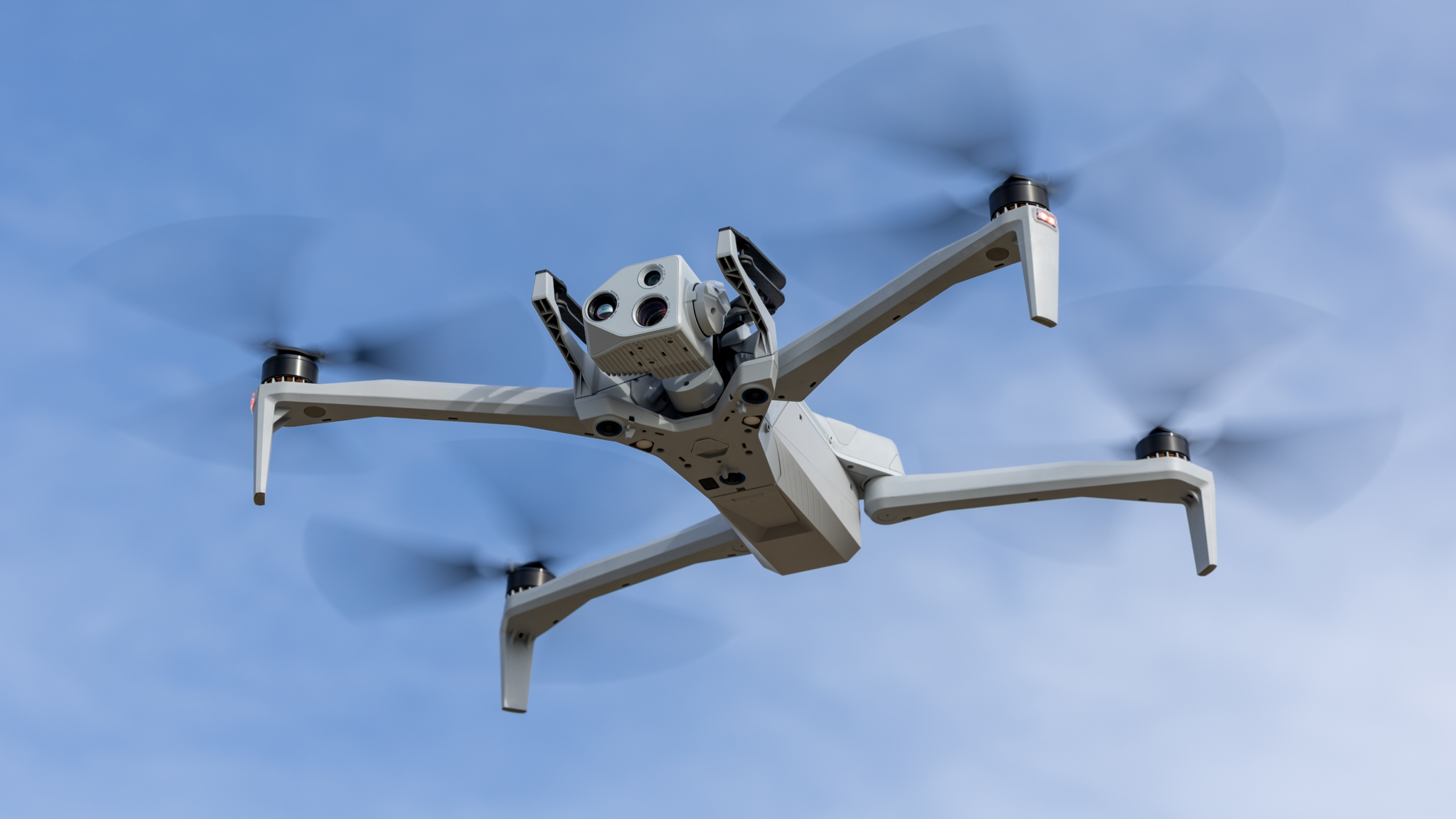 Skydio X10 in flight clear light blue sky 
