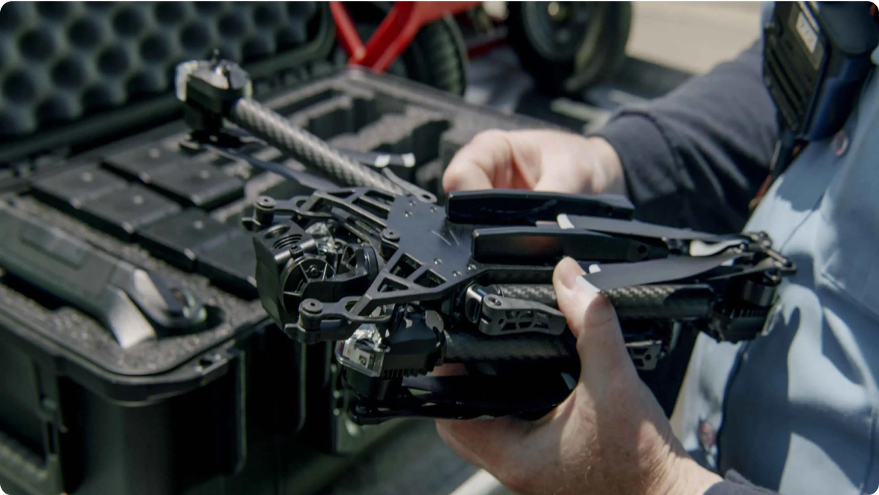 folding a Skydio X2D drone with case in background