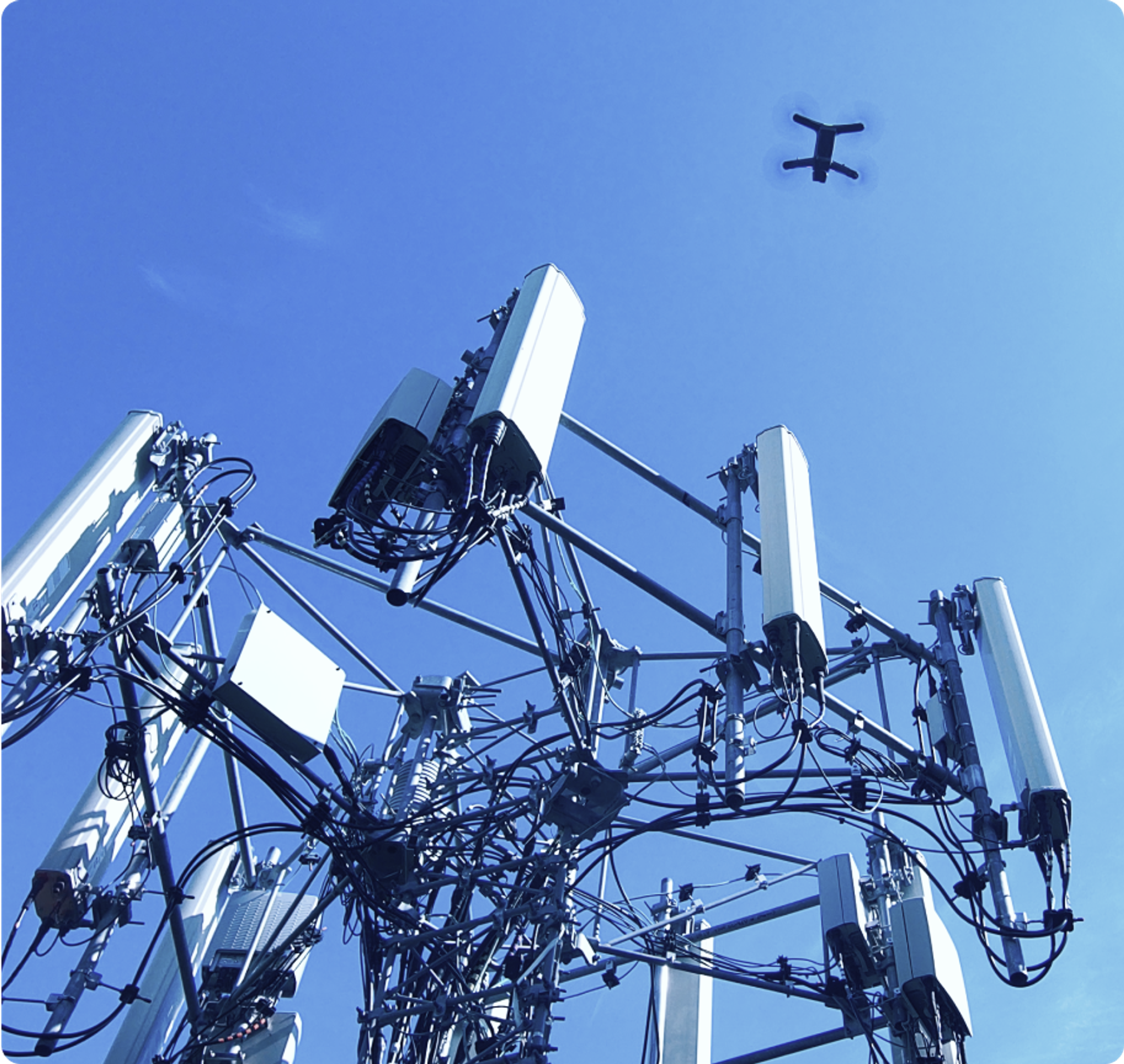 Skydio drone flying above a telecom tower