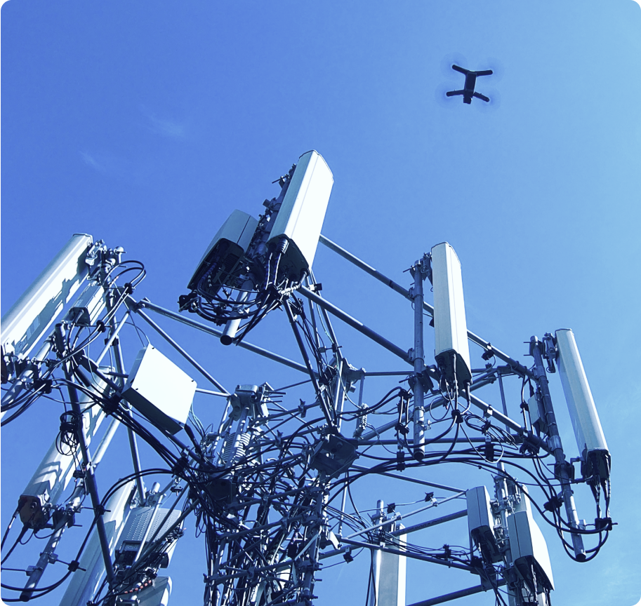 Skydio drone flying above a telecom tower