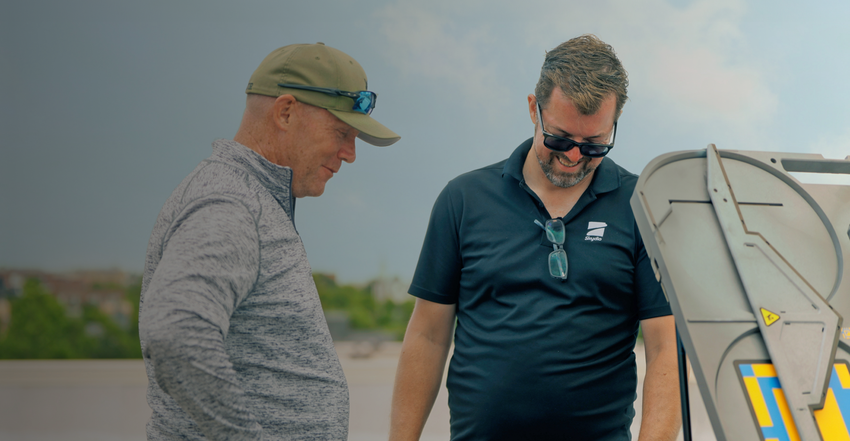 skydio personnel looking down at X10 dock smiling