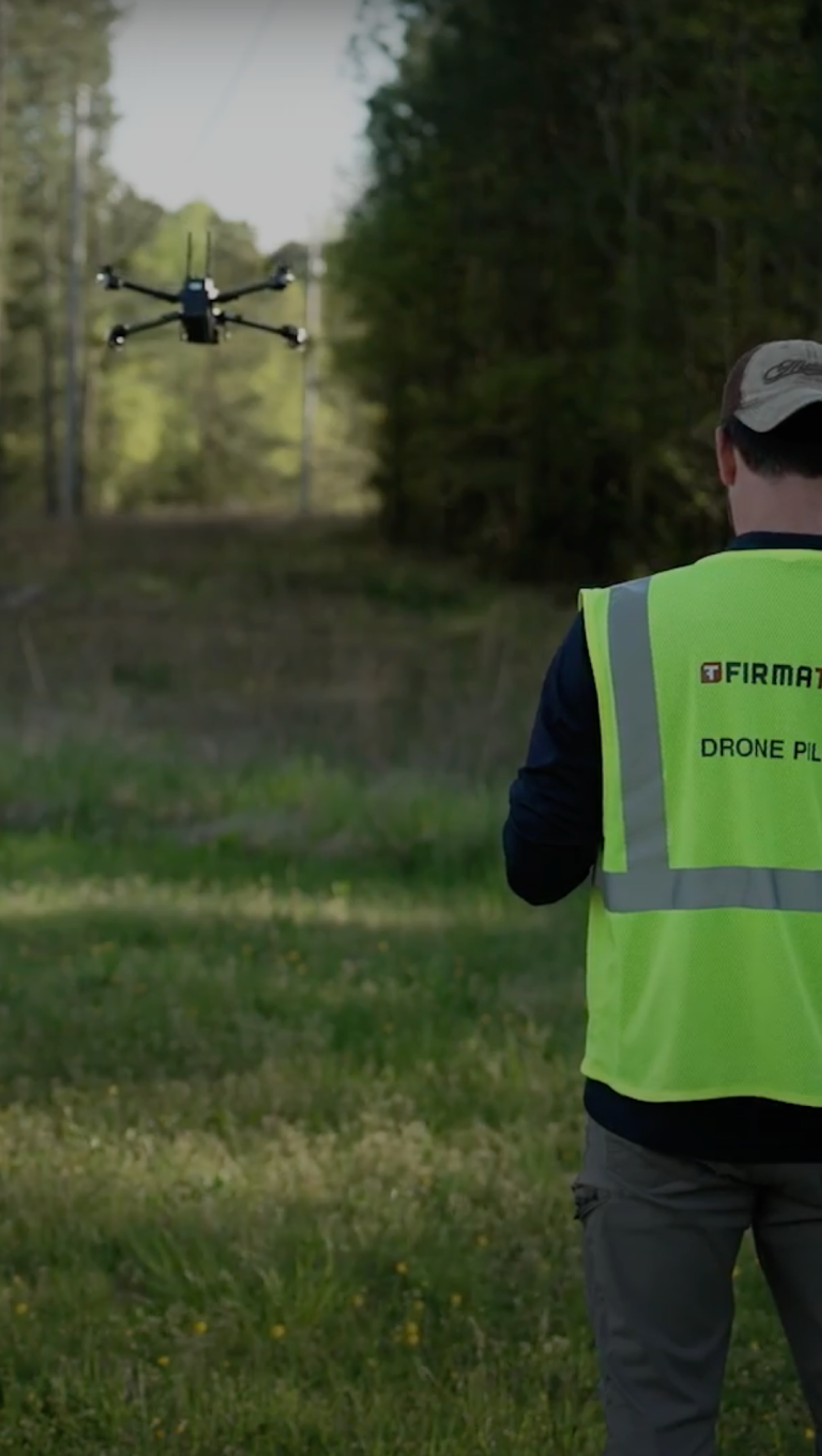Firmatek operator in vest flying a Skydio drone