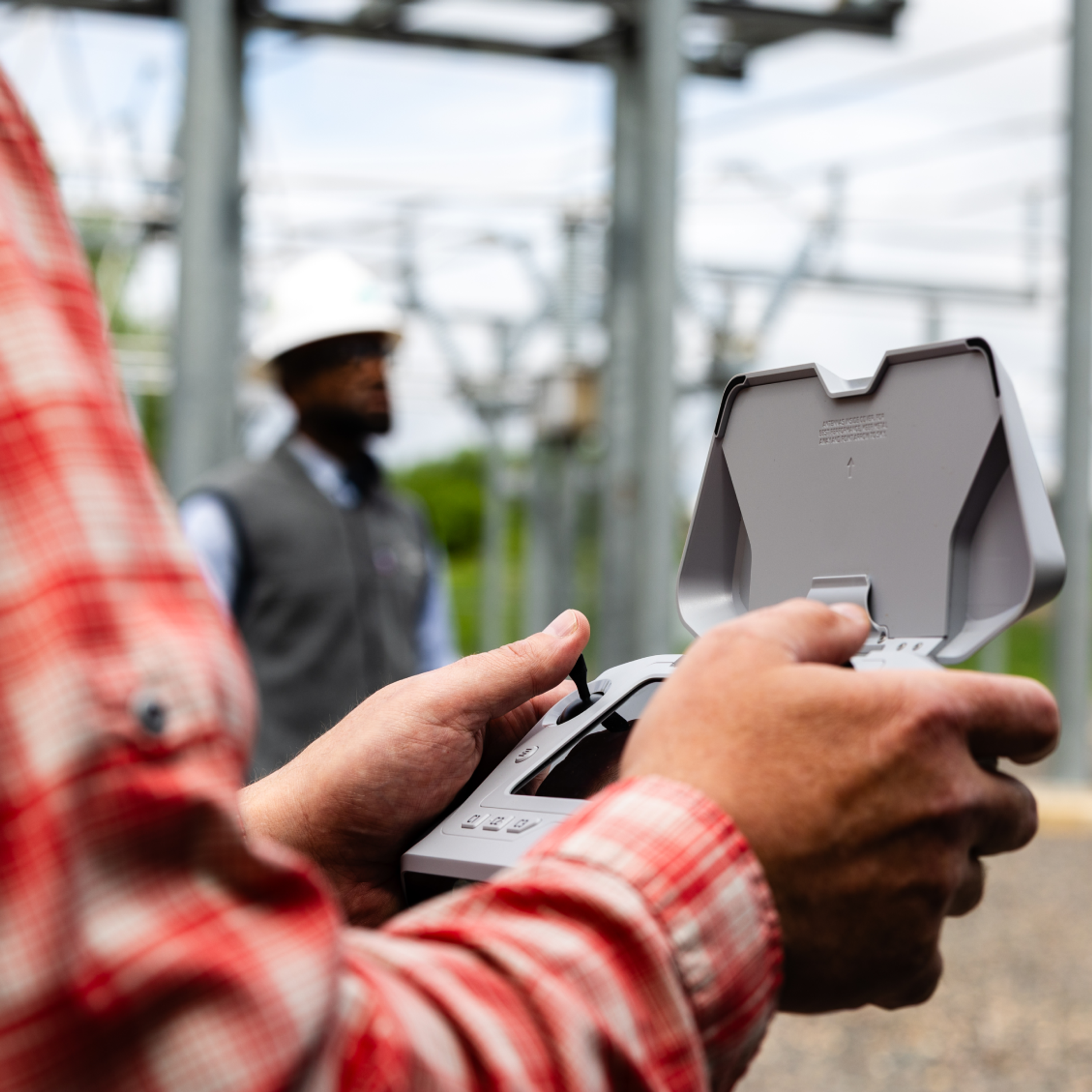 Workers holding a Skydio drone controller