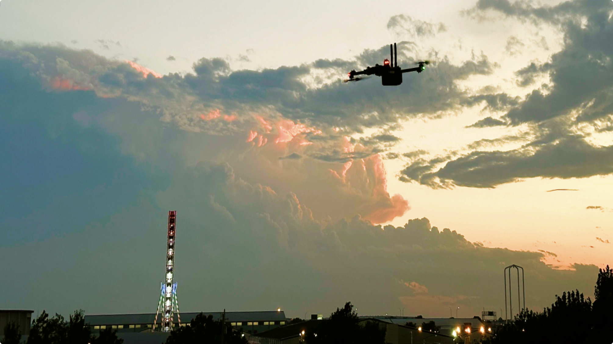 Skydio drone flying at dusk, cloudy sky in the background