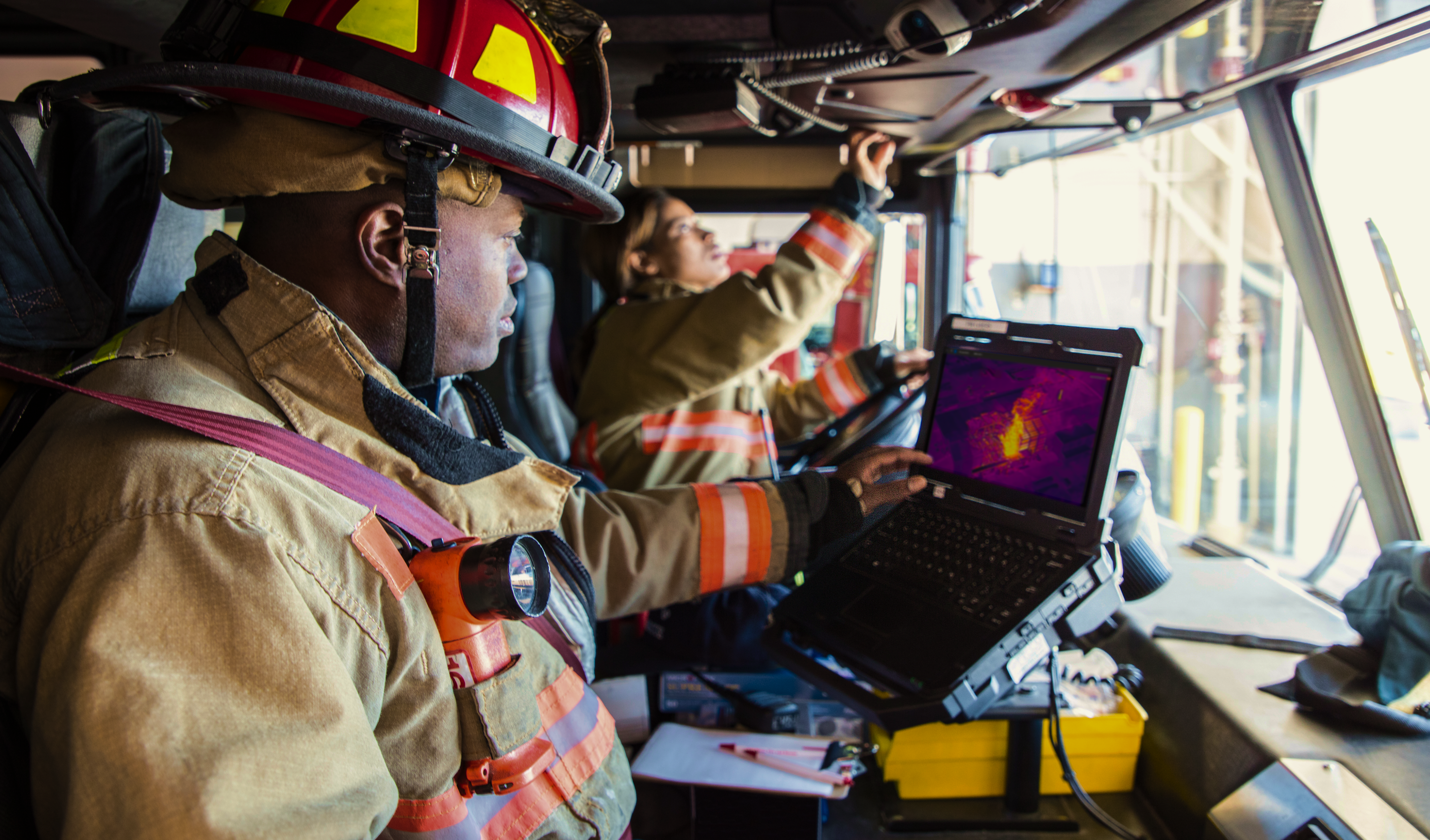 Firefighter looking at live stream thermal footage of fire using Skydio X10 drone footage and Skydio DFR command software