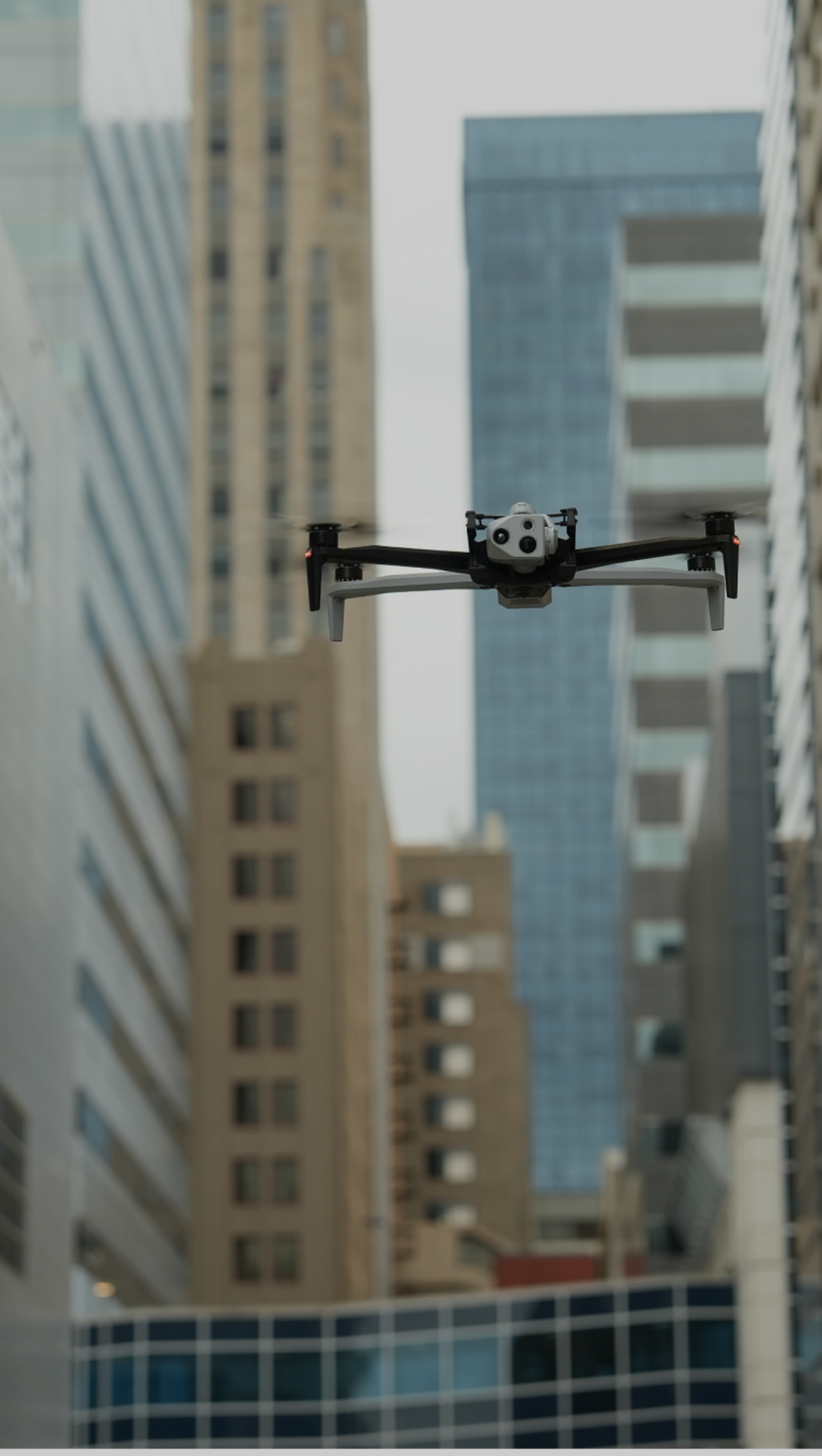 Skydio X10 drone flying in an urban canyon