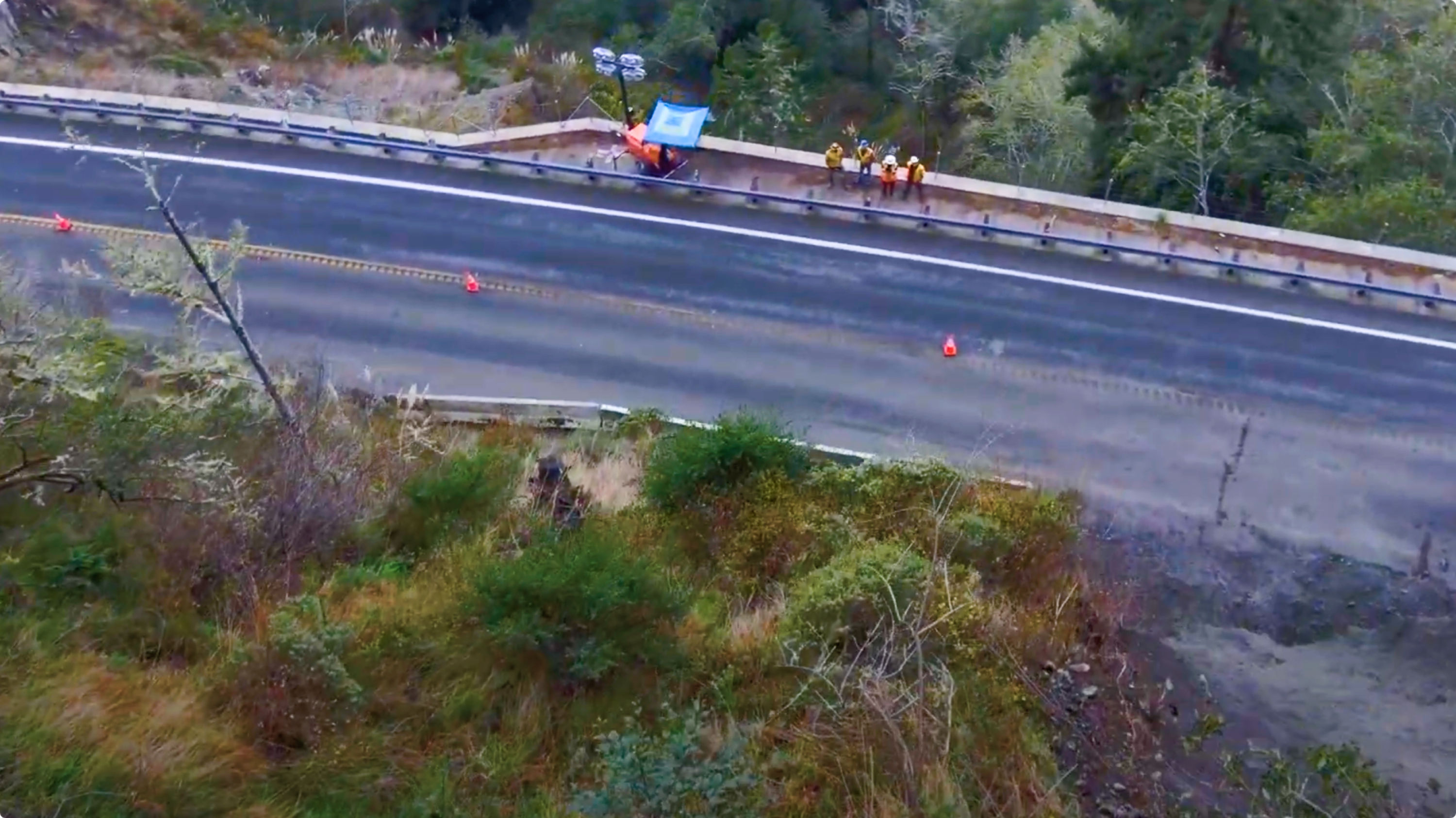 operators flying Skydio drone to view landslide
