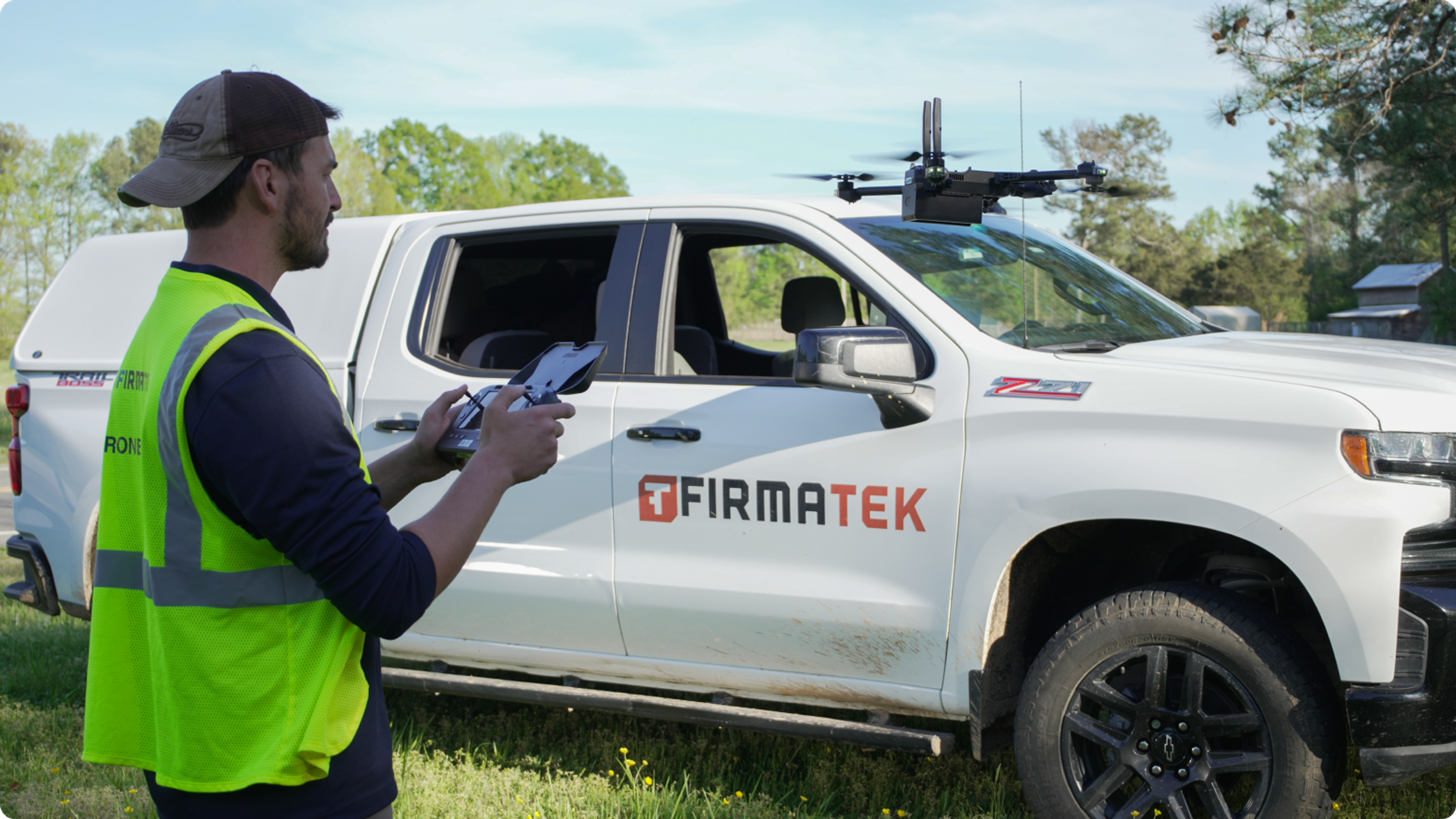 operator flying a Skydio drone for electrical pole inspection with Firmatek truck in background