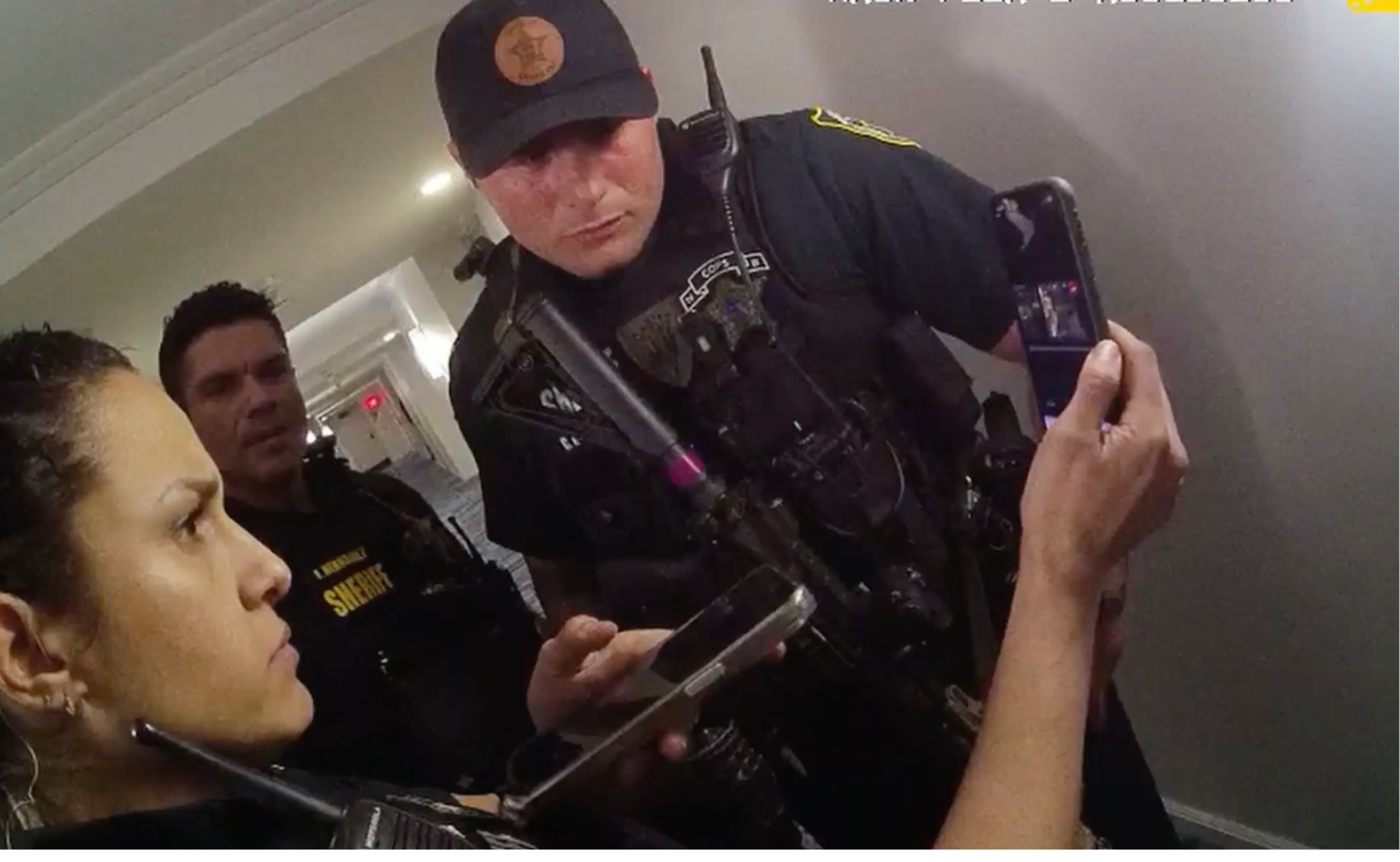 responding officers watching a live stream from a Skydio X10 police drone showing what's happening inside a hotel room before going in