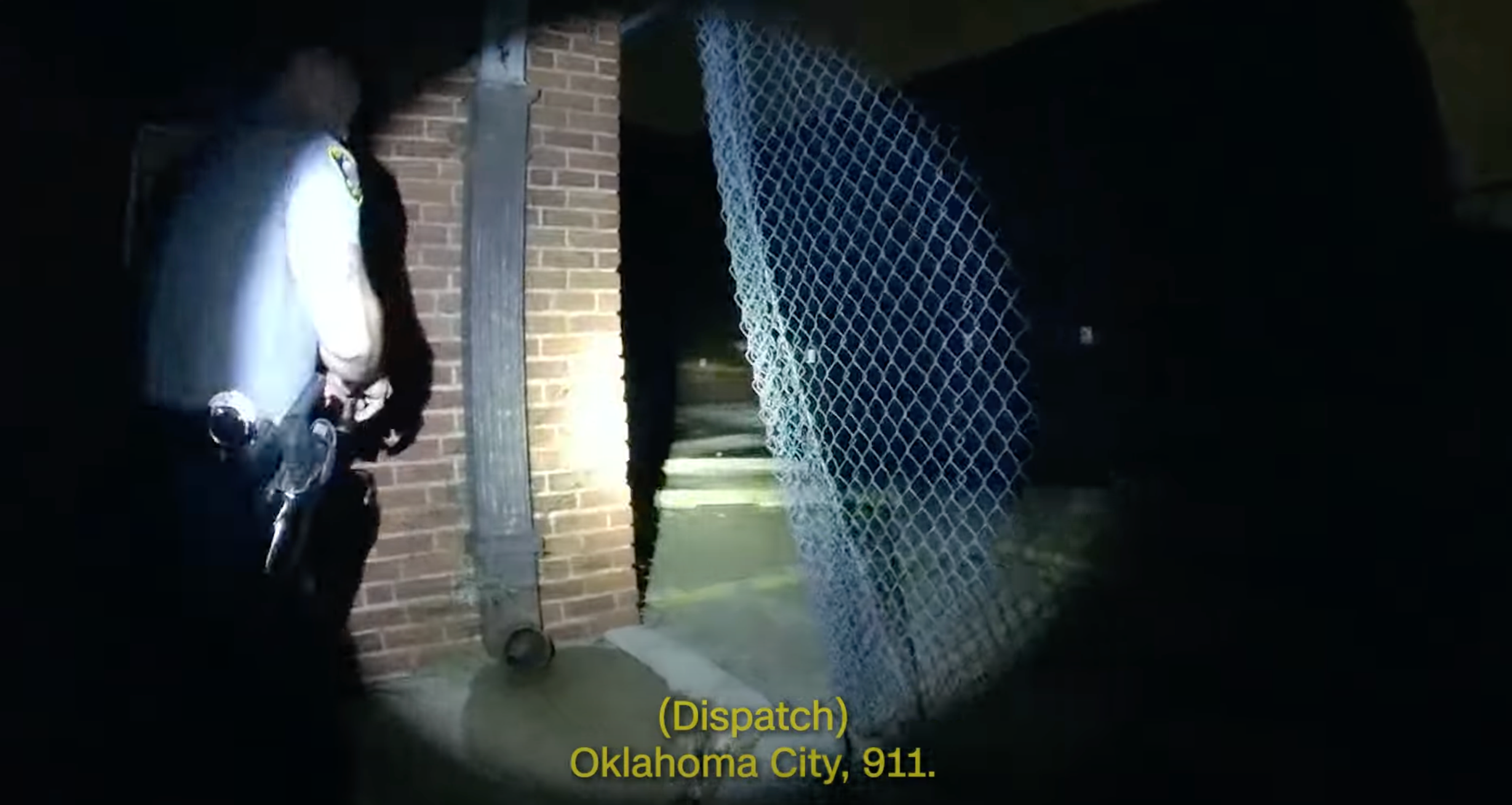 Skydio drone capture image of police officer walking through an opening in a fence