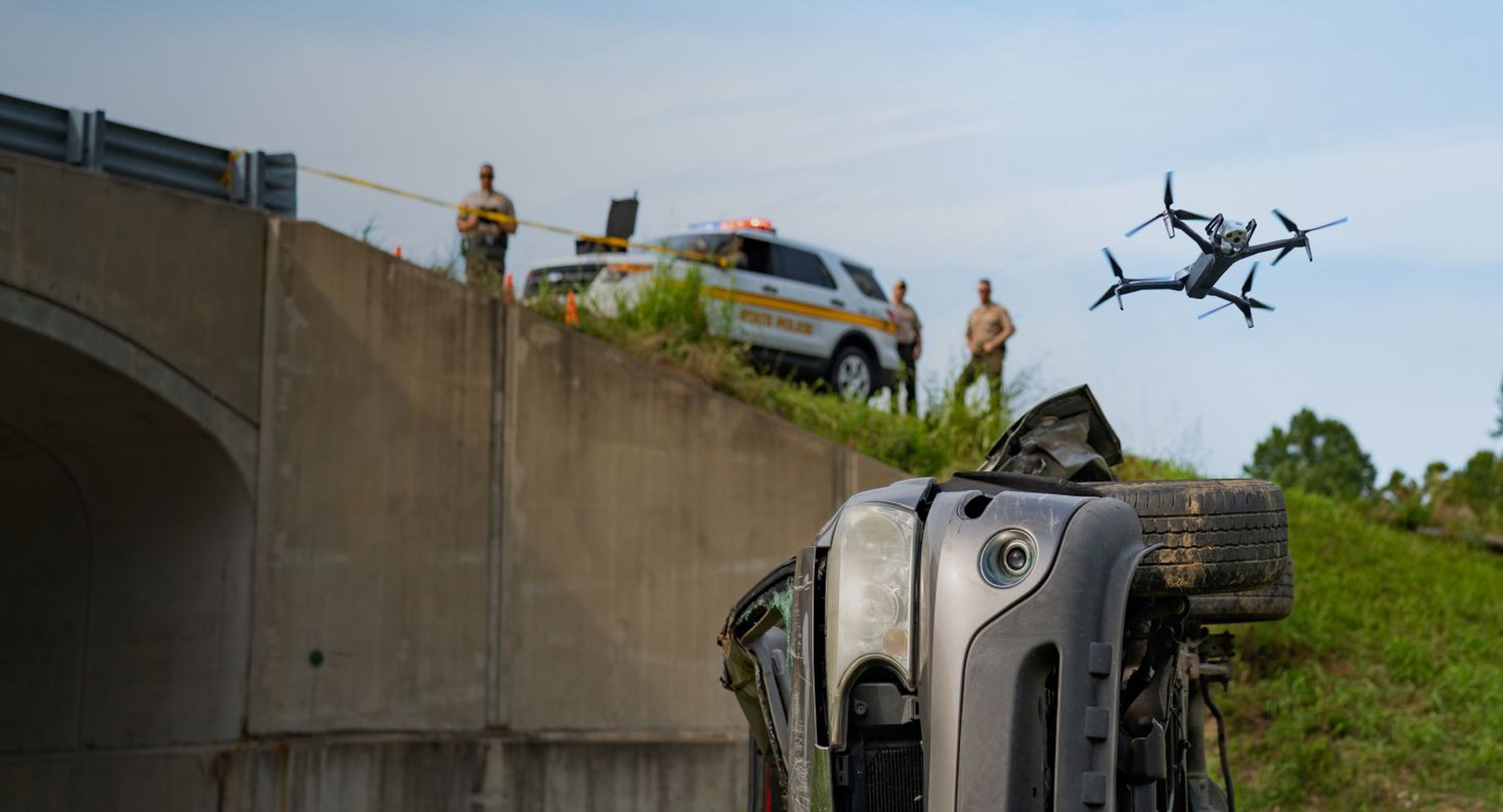 crashed vehicle with Skydio X10 drone with 3D Scan software flying above