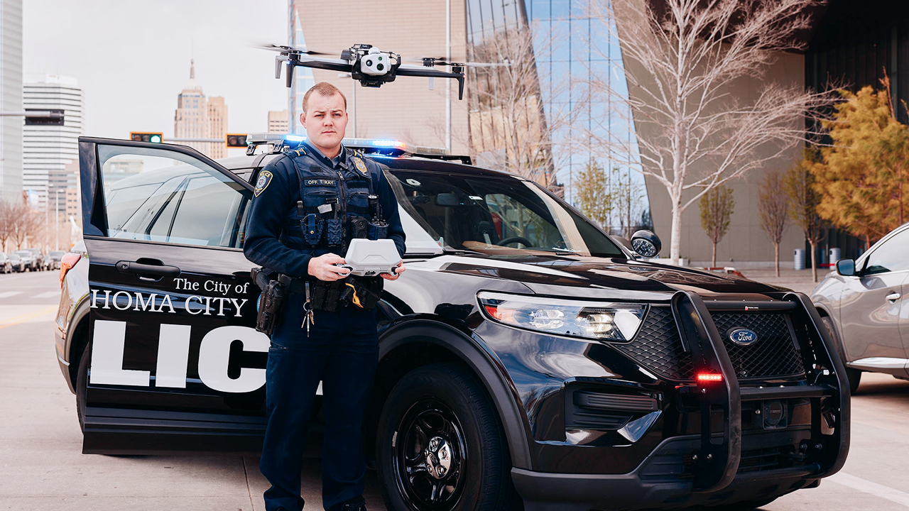 Office launching drone from police car