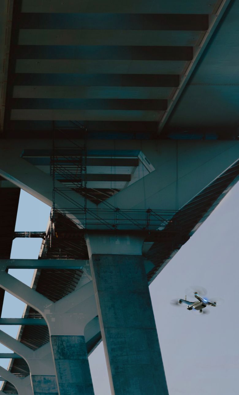 Skydio drone flying a bridge inspection under a cement bridge structure